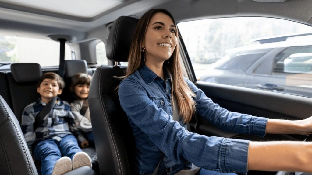 Mother with two young children in the car. 