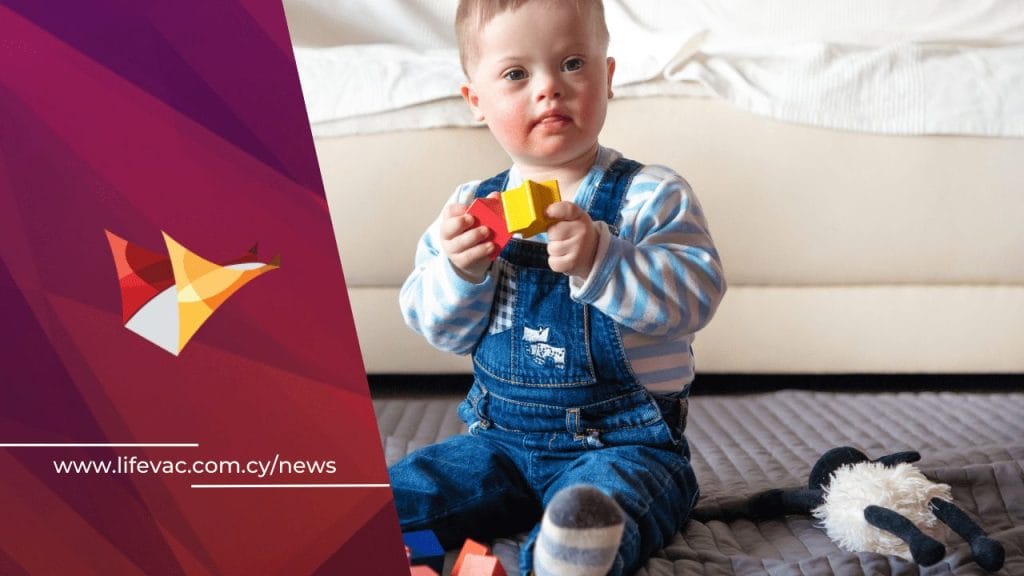 Baby with Down Syndrome plays with toys.