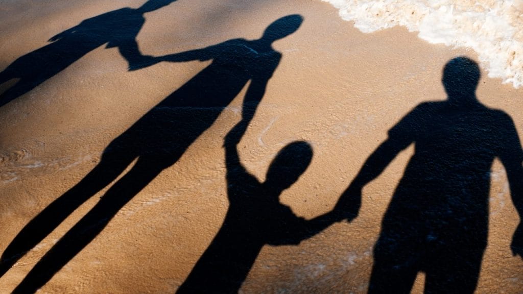 Family at the beach holding hands